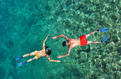 High angle view of people scuba diving in sea