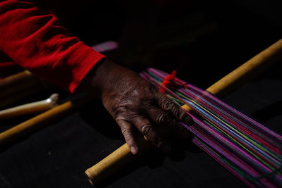 Close-up of man working on loom