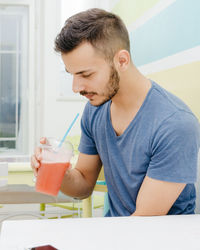 Boy drinking glass on table