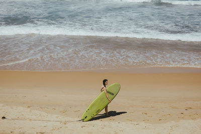 View of surfboard on beach