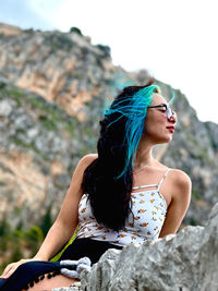 Young woman sitting on rock