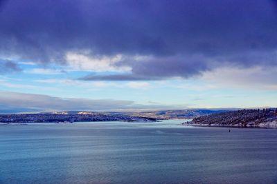 Scenic view of seascape against cloudy sky during winter