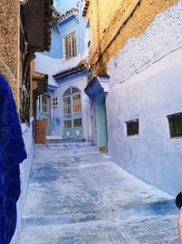 Alley amidst buildings in city during winter