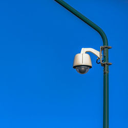 Low angle view of street light against blue sky