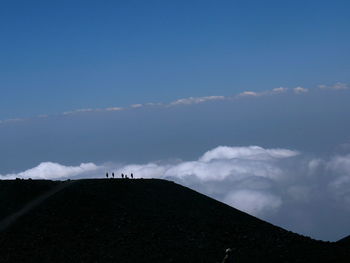 Scenic view of mountains against cloudy sky