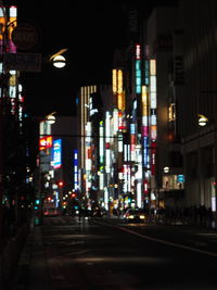 Illuminated road in city at night