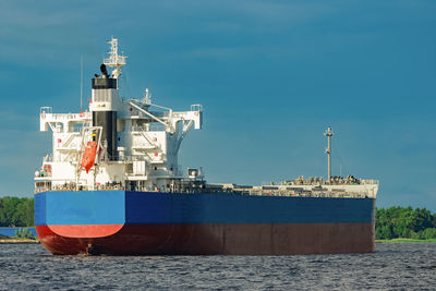 Ship at harbor against blue sky