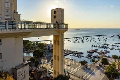 Sunset in the city of salvador behind the lacerda elevator with the bay of all saints and its boats