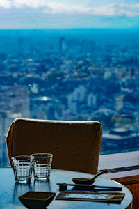 Chairs and sea against sky