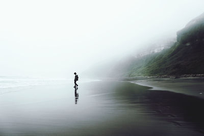 Man on sea against sky