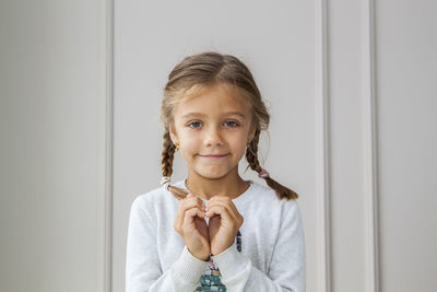 Portrait of smiling girl holding indoors