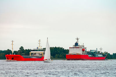 Boat sailing in sea against clear sky