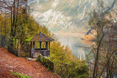 House by lake against mountain