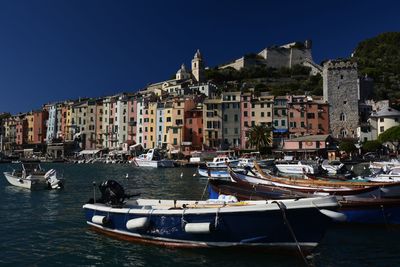 Boats moored in front of canal