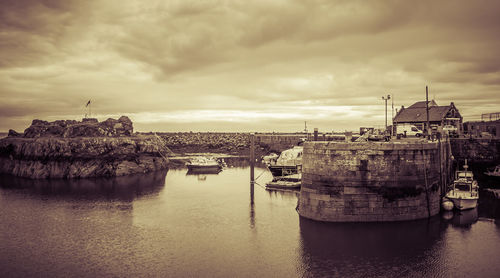 Boats in sea against buildings in city