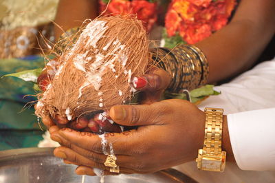 Close-up of woman holding coconut