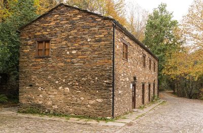 Stone wall of building by street