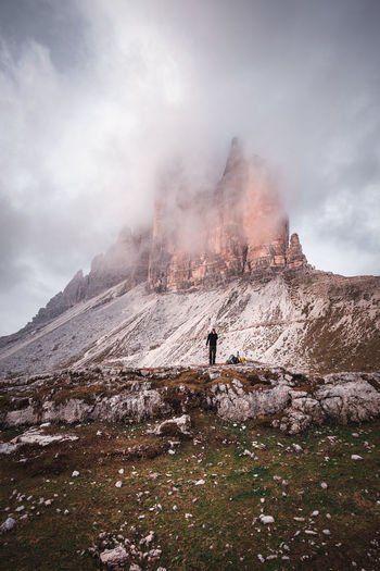 Man standing against rock formation