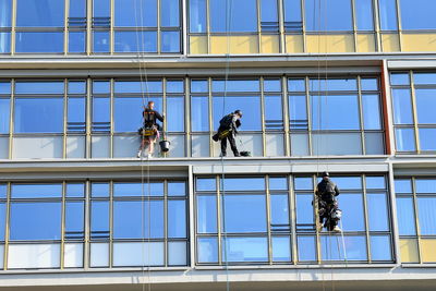 Low angle view of men working at modern building