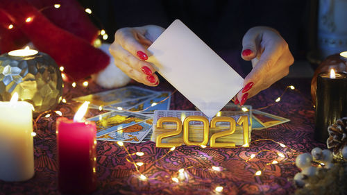 Close-up of illuminated candles on table