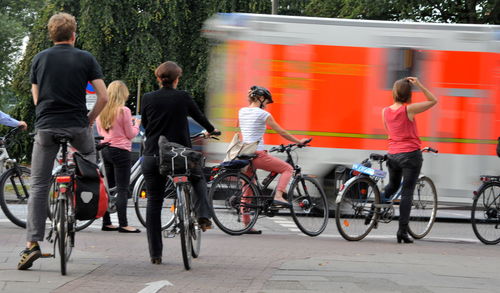 People riding bicycle on street