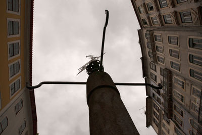 Low angle view of man standing against building