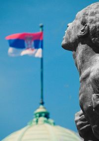 Low angle view of statue against blue sky