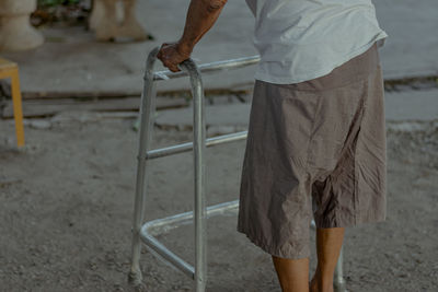 Low section of man working on shore