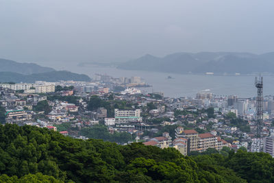 High angle view of buildings and sea against sky