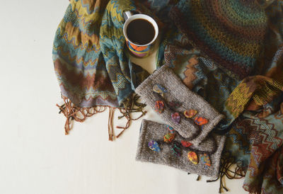 High angle view of coffee cup and scarf