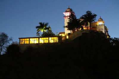 Low angle view of illuminated building against sky at night