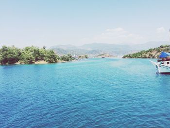 Swimming pool by sea against sky