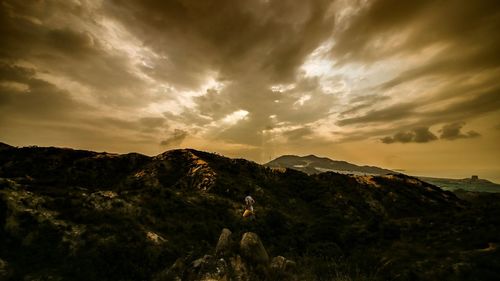 Scenic view of mountains against cloudy sky