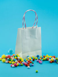 Close-up of multi colored candies against blue background