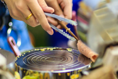 Cropped hands making food