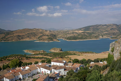 High angle view of townscape by mountain against sky