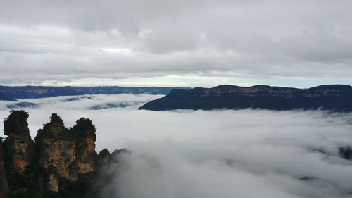 Scenic view of mountains against cloudy sky