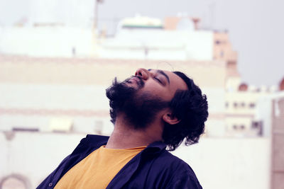 Close-up of young man against sky