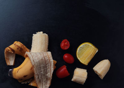 High angle view of fruits on table against black background