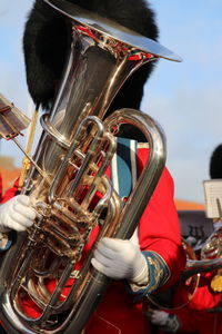 Man playing trumpet while standing outdoors