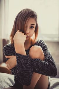 Portrait of beautiful young woman at home