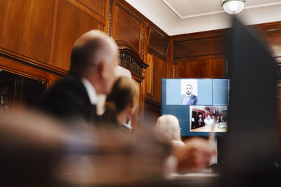 Business colleagues on video conference call with ceo in board room