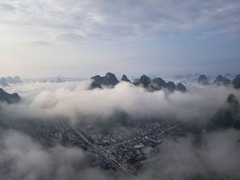 High angle view of snow covered mountains against sky