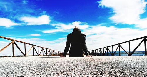 View of suspension bridge against cloudy sky