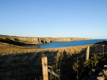 Scenic view of sea against clear blue sky