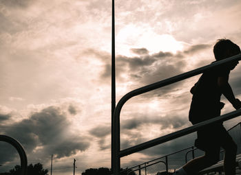 Low angle view of silhouette person against sky during sunset