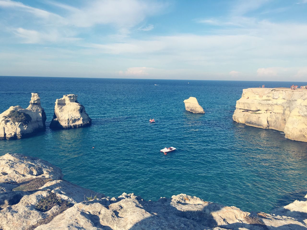 sea, horizon over water, water, tranquil scene, scenics, rock - object, beauty in nature, sky, tranquility, beach, shore, nature, blue, seascape, rock formation, non-urban scene, cloud, day, cloud - sky, cliff, outdoors, tourism, vacations, no people