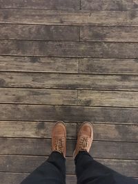 Low section of man standing on deck