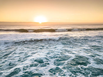 Scenic view of sea at sunset