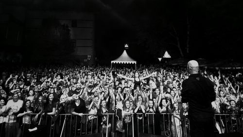 Group of people standing in the dark